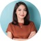 portrait confident smiling asian woman standing with arms folded looking camera isolated blue background 1 1